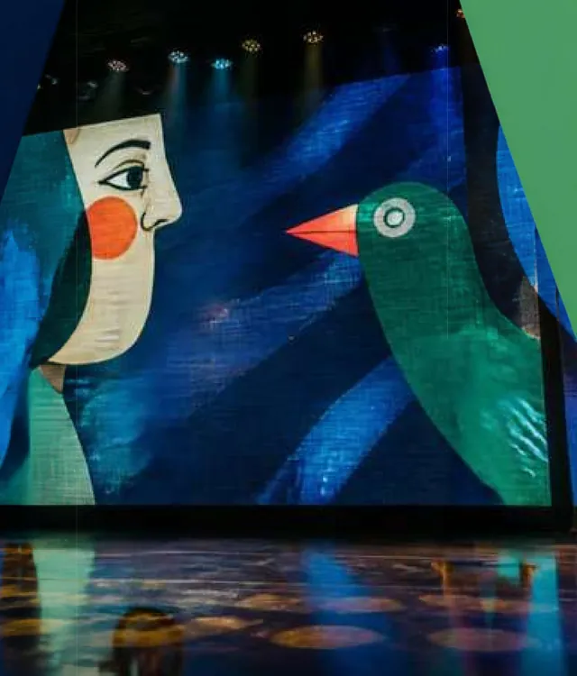 Ilustração de um rosto e de um pássaro verde no painel de LED